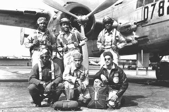 Tuskegee Airmen bomber pilots pictured near their aircraft during World War II.