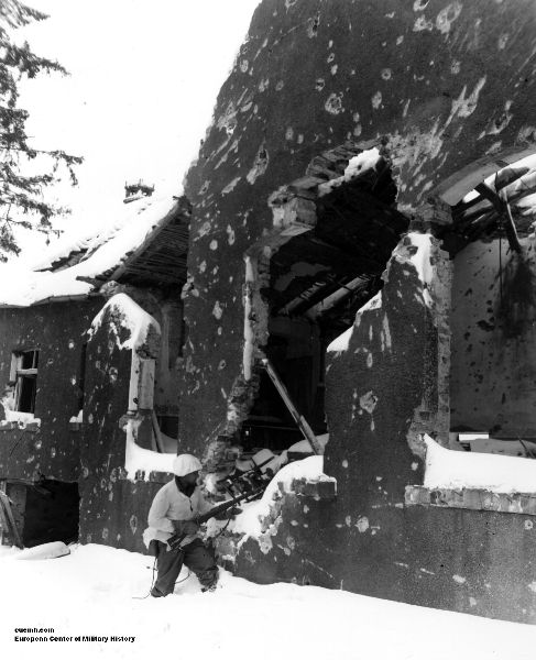 Battle of the Bulge, 1st Infantry Division army soldier clearing a blown up building during the war.