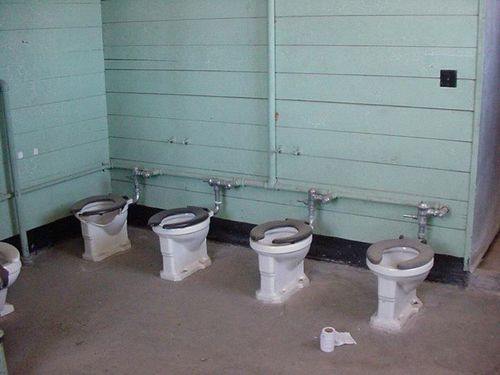 Military barracks toilets are too close together for soldiers.